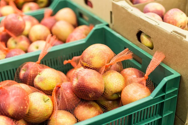 Apples in the boxes at the supermarket