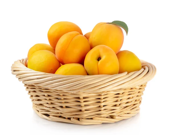 Fresh apricots in the basket are isolated on a white background. — Stock Photo, Image