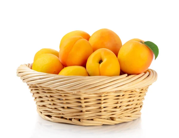 Fresh apricots in the basket are isolated on a white background. — Stock Photo, Image