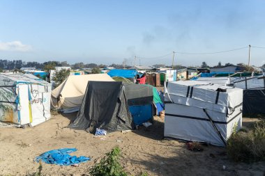 CALAIS, FRANCE - OCTOBER 24, 2016:Refugees' tents in the Jungle of Calais during the eviction of the illegal refugee camp in the north of France clipart