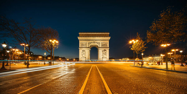 The Arc de Triomphe de l'Etoile (Triumphal Arch of the Star) at Night. It is one of the most famous monuments in Paris, standing at the western end of the Champs-Elyseees