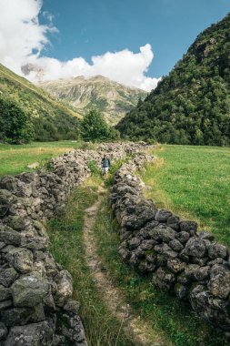 FRENCH ALPS, FRANCE - AUGUST 11, 2016: People hiking in the National Parc of Ecrins clipart