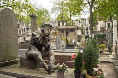 PARIS, FRANCE - APRIL 28, 2016: Vaslav Nijinsky's grave in the Montmartre Cemetery. He was a Russian ballet dancer and choreographer, cited as the greatest male dancer of the early 20th century clipart