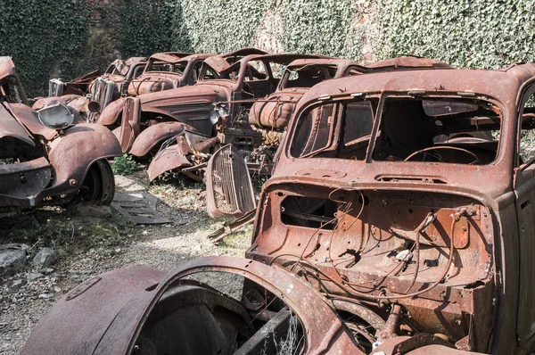 old rusty deserted cars in Oradour sur Glane, France. In this village, 642 of its inhabitants were massacred by a German Waffen-SS company in the second world war