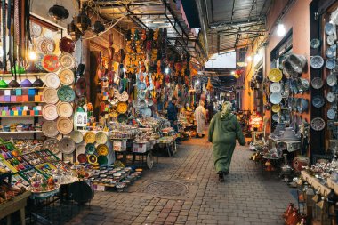 MARRAKESH, MOROCCO - JANUARY 3, 2017: Moroccan woman in the souk near the square of Jemaa el-Fna clipart