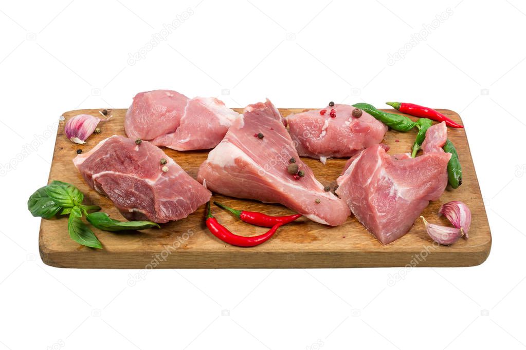 Raw chopped pork meat on wooden cutting board with herbs and spices isolated on white background. cooking concept. close up