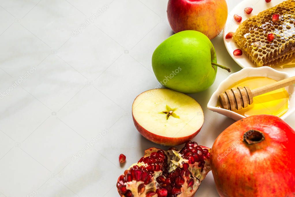 Honey, apple and pomegranate. traditional food for Jewish New Year Holiday, Rosh Hashanah. close up with copy space. shallow depth of field
