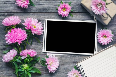 boş fotoğraf çerçevesi ile güzel buket pembe aster, Not defteri ve hediye kutusu. kadar alay et. Düzen. flatlay. tatil ya da düğün arka plan. üstten görünüm
