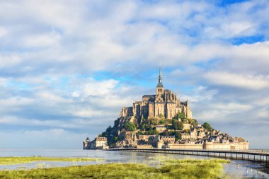 Le Mont Saint Michel abbey on the island, Normandy, Northern France, Europe at sunrise clipart