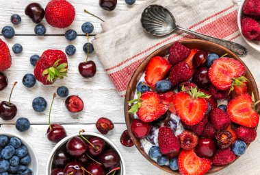 taze ahududu, çilek, kiraz ve yaban mersini bir kaşıkla berry yoğurt veya chia puding kase. sağlıklı kahvaltı. Üstten Görünüm