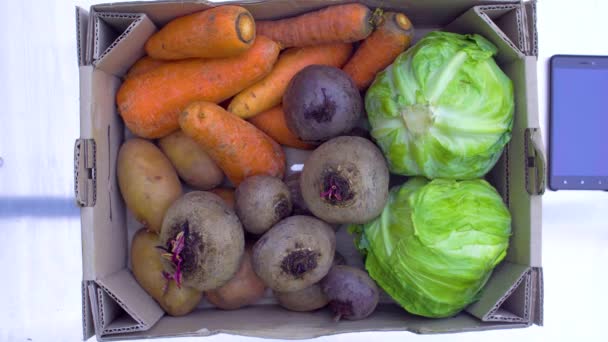 Box with vegetables on the table. Top view — Stock Video