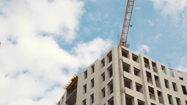 Construction cranes for building on a background of blue sky with white clouds — Stock Video