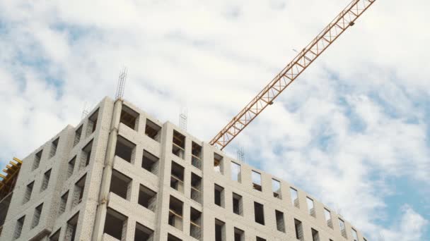 Construction cranes for building on a background of blue sky with white clouds — Stock Video