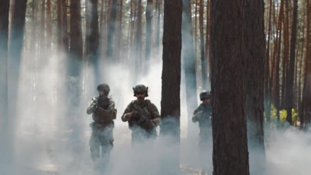 Soldiers in full ammunition takes a position in a smoky forest — Stock Video