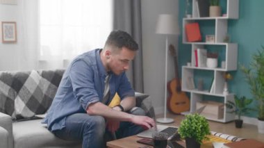 Young Man is Angry because of Bad News on a Laptop