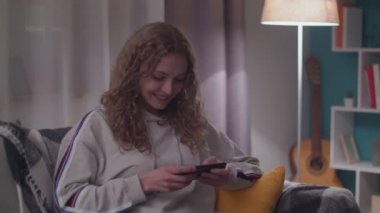 Akşam Güzel Genç Kadın Onu Rahat Oturma Odasında Bir Kanepede Rahatlatır