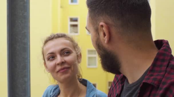 A couple talking on the fire escape behind the house — Stock Video