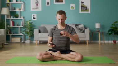 Evde yoga yapan genç adam.