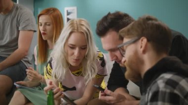 Akıllı telefon ile mutlu arkadaşlar gün oturma odasında komik videolar izle