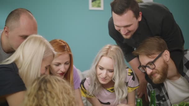 Group of friends watch funny memes on phone while sitting on sofa — Stock Video