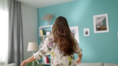 Yumuşak bir oyuncak ile oturma odasında dans Mutlu güzel kadın