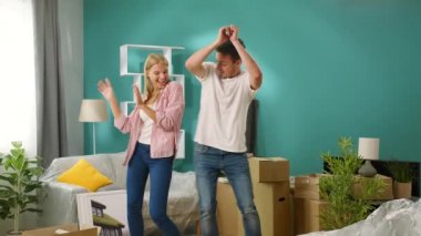 Genç çift yeni evlerinde dans ederken eğleniyor