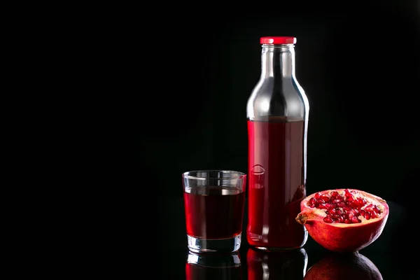 Granatäpple Juice Ett Glas Flaska Och Hälften Granatäpple Svart Bakgrund — Stockfoto