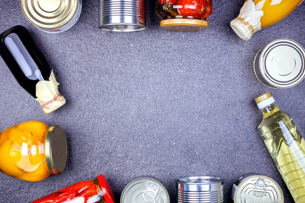 Donations food with canned food on the table with copy space. Various canned vegetables, meat, fish and fruits in tin and glass cans. Top view.