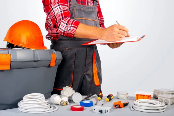 Electrician signs a work contract. Worker draws up a work plan.