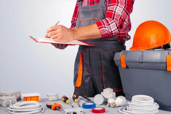 stock image Electrician draws up a work plan. Contract work. 