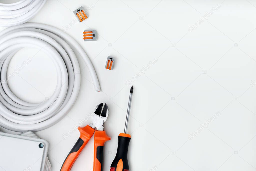 Electrician equipment and tools on white background with copy space. top view.