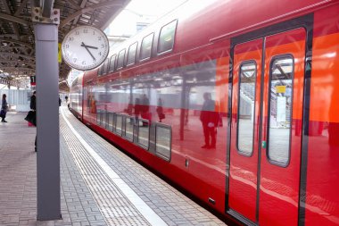 İstasyonda saatli modern tren var. Seçici odak.
