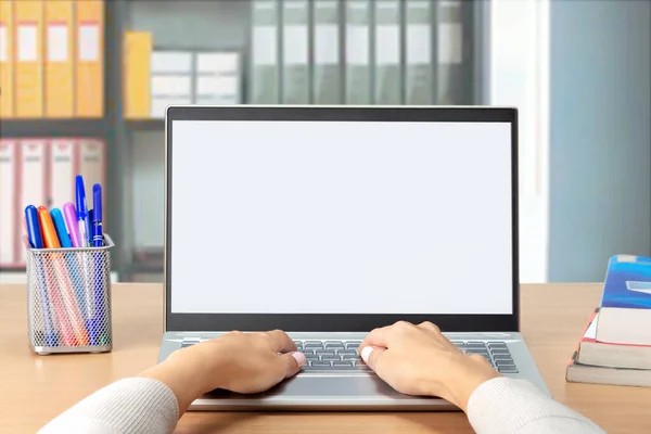 Woman\'s hands typing on computer laptop with white blank screen at office. Student e-learning distance training course study work at home office.