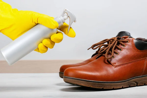 Disinfection to clean shoes from coronavirus and bacteria. Concept shoe shine and care.