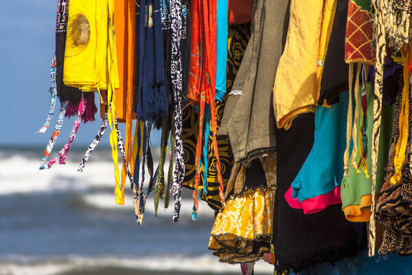 Street vendor of clothes, swimsuits, bikinis and cangas on a beach in Brazil