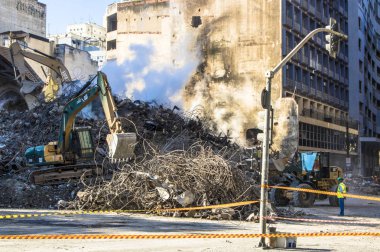 Sao Paulo, Brazil. May 04, 2018. Brazilian Firefighters and machinery remove debris where a 24-story building collapsed after a fire in downtown Sao Paulo, Brazil. The Wilton Paes de Almeida Building, site of the former headquarters of the Federal Po clipart