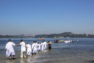 Sao Paulo, Brazil, November 15, 2013. Baptism ceremony of faithful of the Evangelical Baptist Church, in Praia do Sol Park on the banks of the Guarapiranga Dam, south of Sao Paulo, clipart