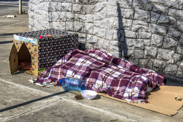 Sao Paulo, SP, Brazil, May 24, 2018. Belongings of a homeless person and a dog house made of cardboard in a corner in the south zone of Sao Paulo