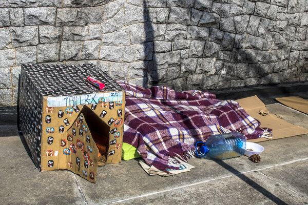 Sao Paulo, SP, Brazil, May 24, 2018. Belongings of a homeless person and a dog house made of cardboard in a corner in the south zone of Sao Paulo