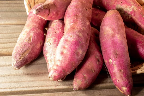 Sweet potato in basket on jute background in Brazil