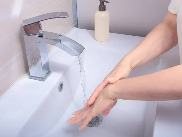 Coronavirus pandemic prevention wash hands with soap warm water , rubbing nails and fingers washing frequently or using hand sanitizer gel. Hygiene concept
