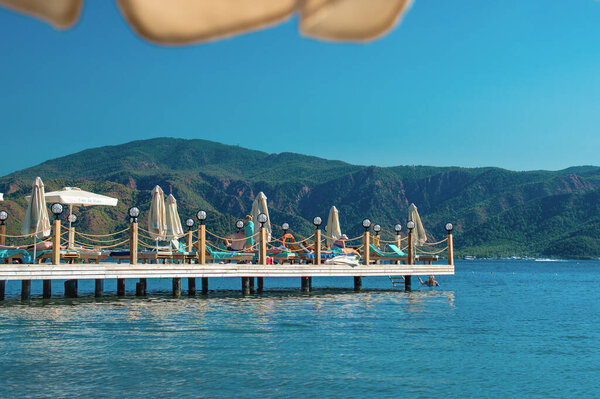 Marmaris, Turkey - October 13, 2020: People are stand and lie on the on platform in the sea. platform are used to save marine ecosystem and for a relaxing holiday at the sea