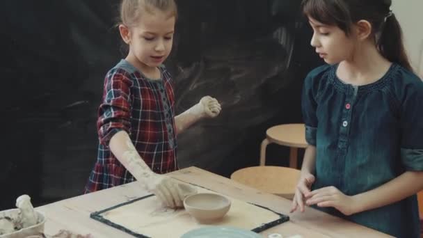 Lesson on clay modeling. two little girls little sister are engaged in modeling of clay — Stock Video