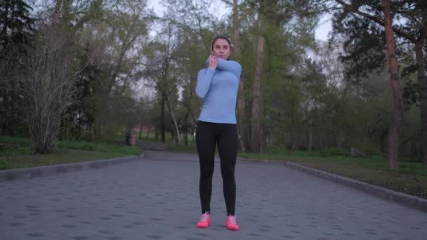 Mädchen dehnt sich vor dem Abendlauf — Stockvideo