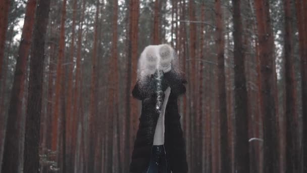 The red-haired girl throws snow up and laughs. slow motion — Stock Video