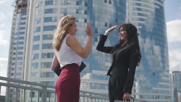 Concept of success in business and the joy of achieving the goal. two business women happily give each other high five and funny celebrate success — Stock Video