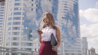 yakın çekim portre resmi bir takım elbise içinde bir kadın. Genç iş kadını manifatura bir cep telefonuna bir mesaj