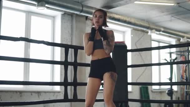 Девушка боксёр разогревается на ринге — стоковое видео