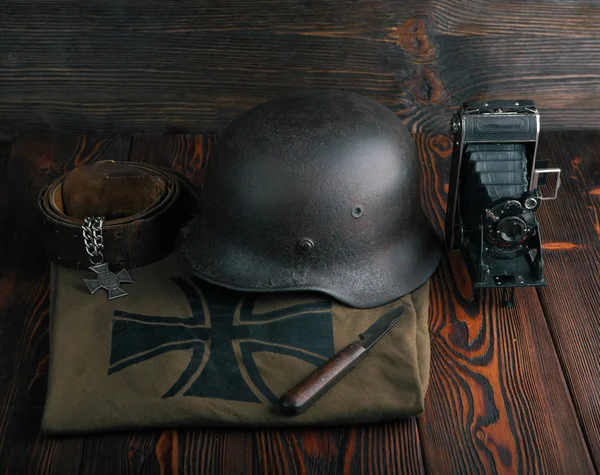 Rusty german army helmet from second world war. The inscription on a medal in the German language - for faithful services in the police.