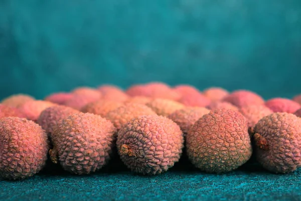 Lychee on the background of blue cement. Turquoise background.